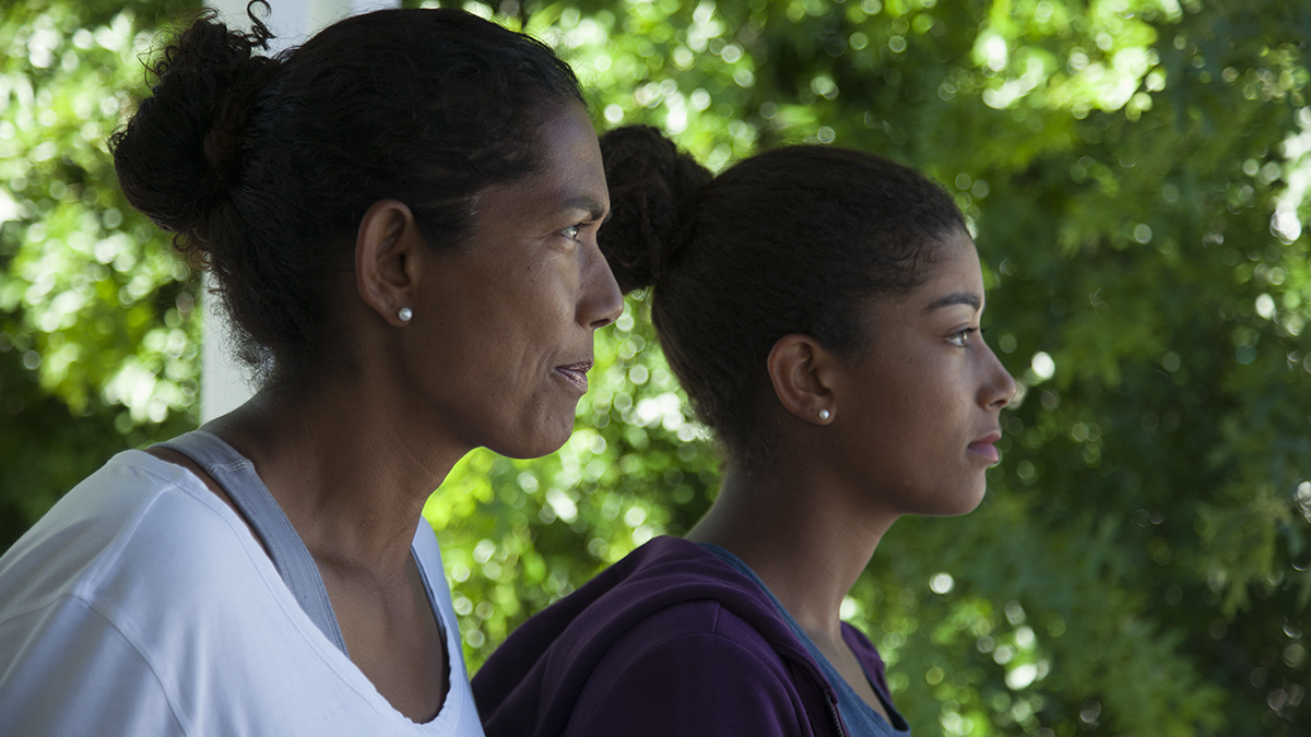 Reyana Abrahams-Ewing, a tennis prodigy in apartheid South Africa, and her daughter, Salma stare off into the distance.