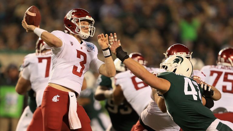 Washington State quarterback Tyler Hilinksi throws football in the Holiday Bowl against Michigan State