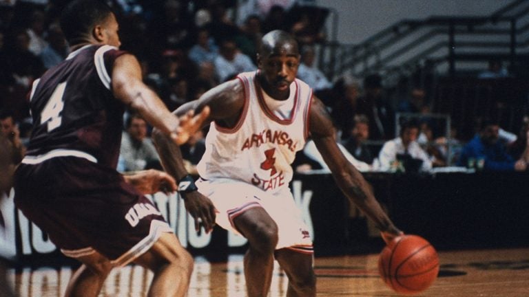 Arkansas State student Arthur Agee dribbling basketball while University AR-Little Rock student guards him during game