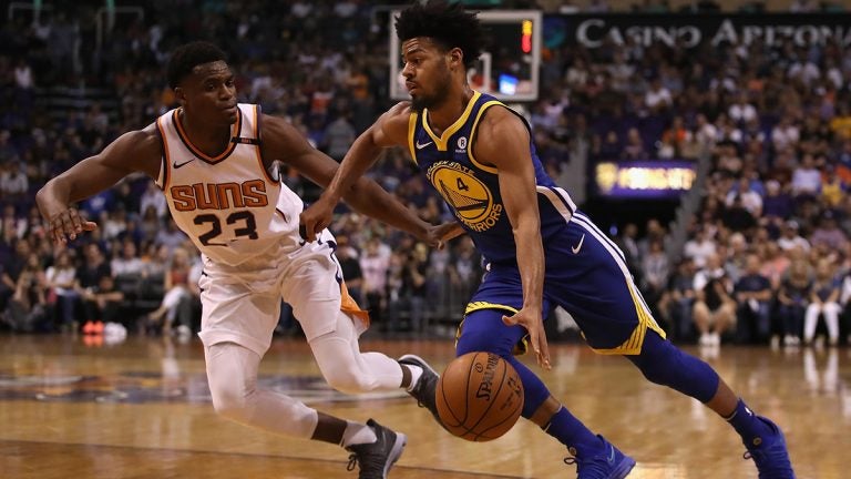 Quinn Cook of Golden State drives past Danuel House Jr. of Phoenix.