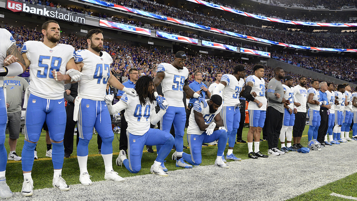 Jalen Reeves-Maybin and Steve Longa of the Detroit Lions of the NFL kneel during the national anthem to protest