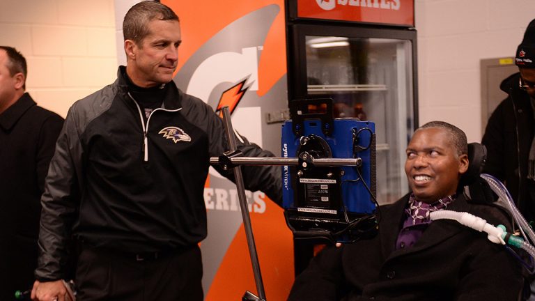 Baltimore Ravens coach John Harbaugh and former player O.J. Brigance talk before football game