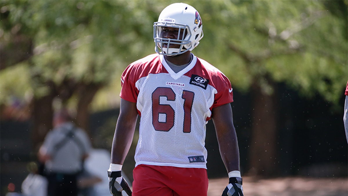 Arizona Cardinals defensive football end Moubarak Djeri walking outside in uniform