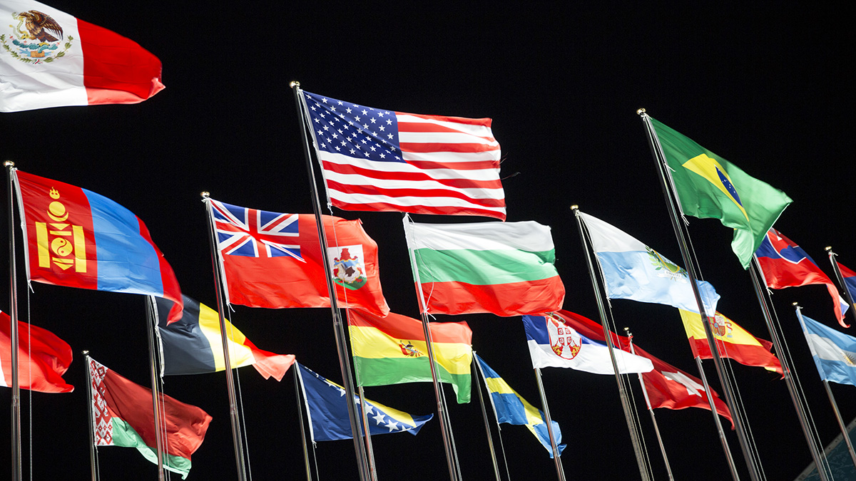 National flags from different countries waving in the wind.