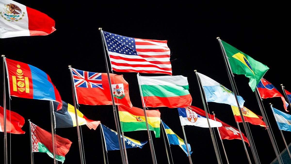 National flags from different countries waving in the wind.