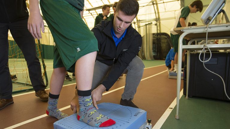 A student gets tested on their balance during a concussion test