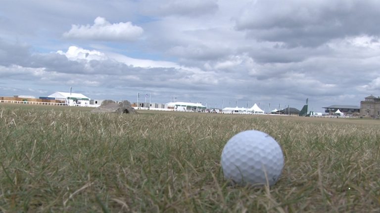 Golf ball laying in the grass at St. Andrews Links