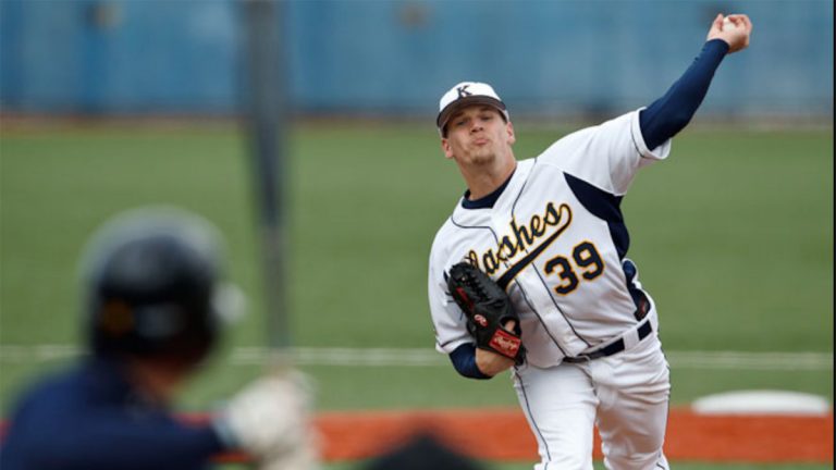Kent State baseball player in white and navy uniform pitches baseball