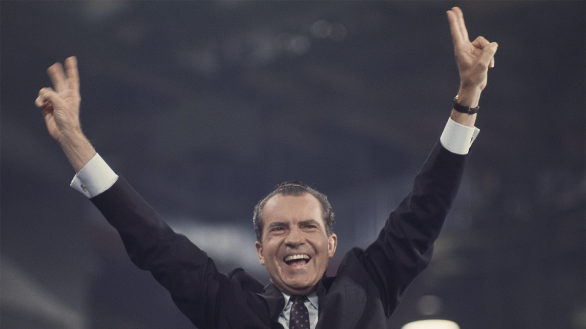 Former President Richard Nixon smiling and waving