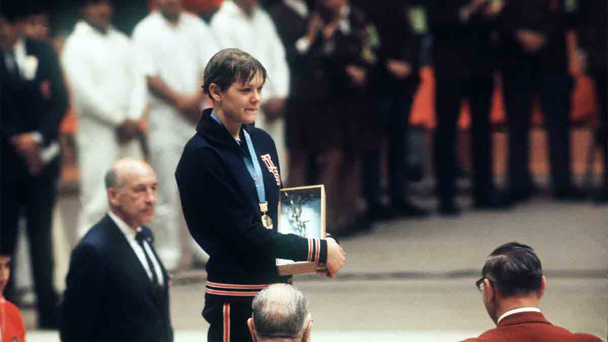 Debbie Meyer poses on the podium with her gold medal at the Mexico Olympic Games in 1968