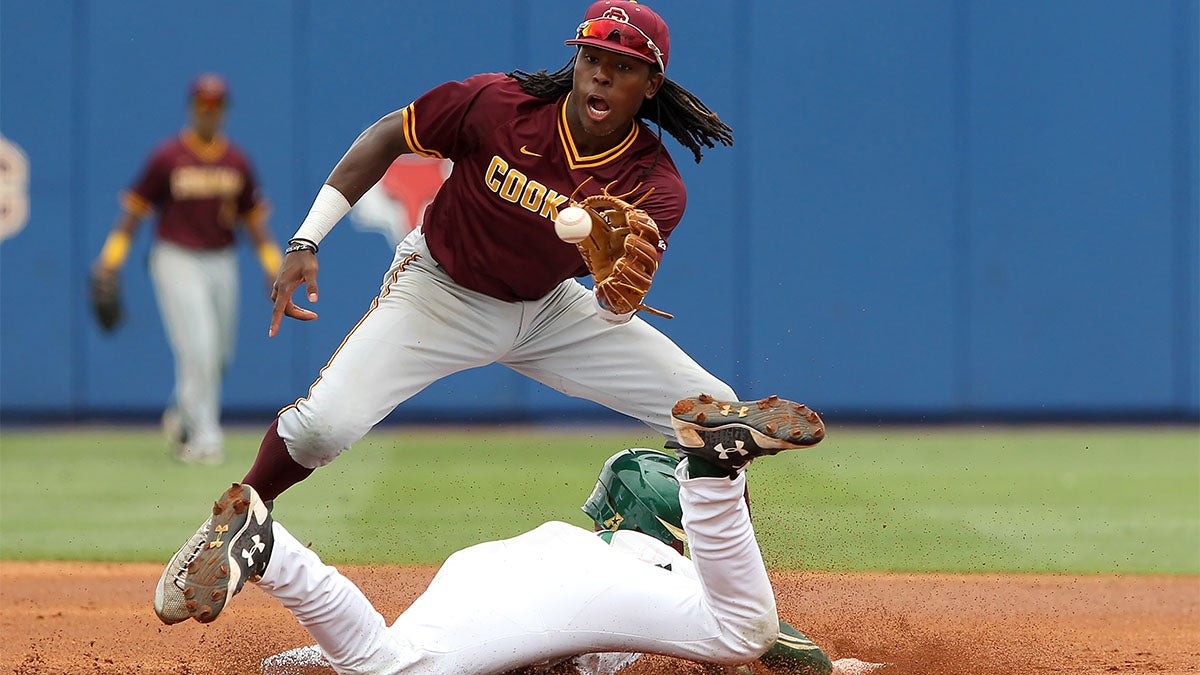 Demetrius Sims attempts to catch the ball as Duke Stunkel slides into second base