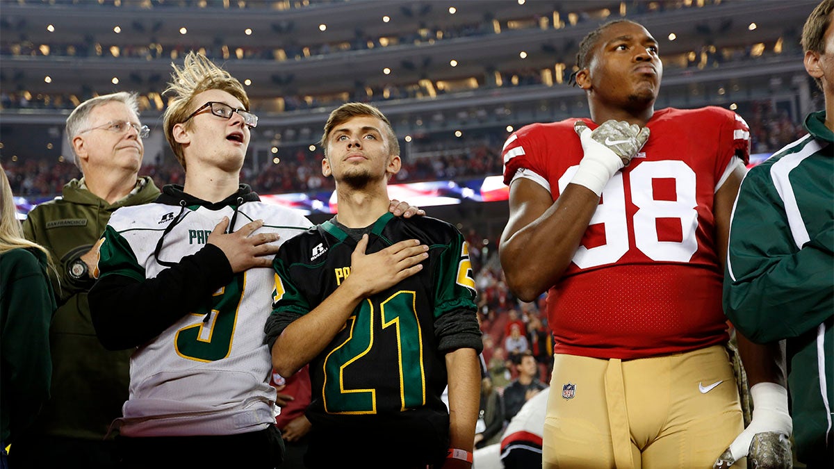 Kaleb Nelson and Austyn Swarts of the Paradise High School football team with San Francisco 49er Ronald Blair III