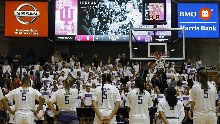 Female basketball players looking into a crowd all wearing the same jersey