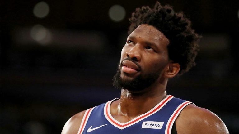 Joel Embiid, professional basketball player for the Philadelphia 76ers looks up towards his right.