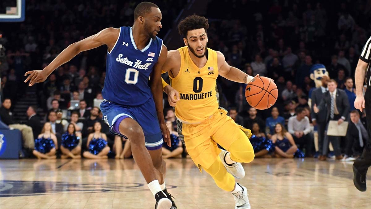 Markus Howard dribbling the ball against a defender.