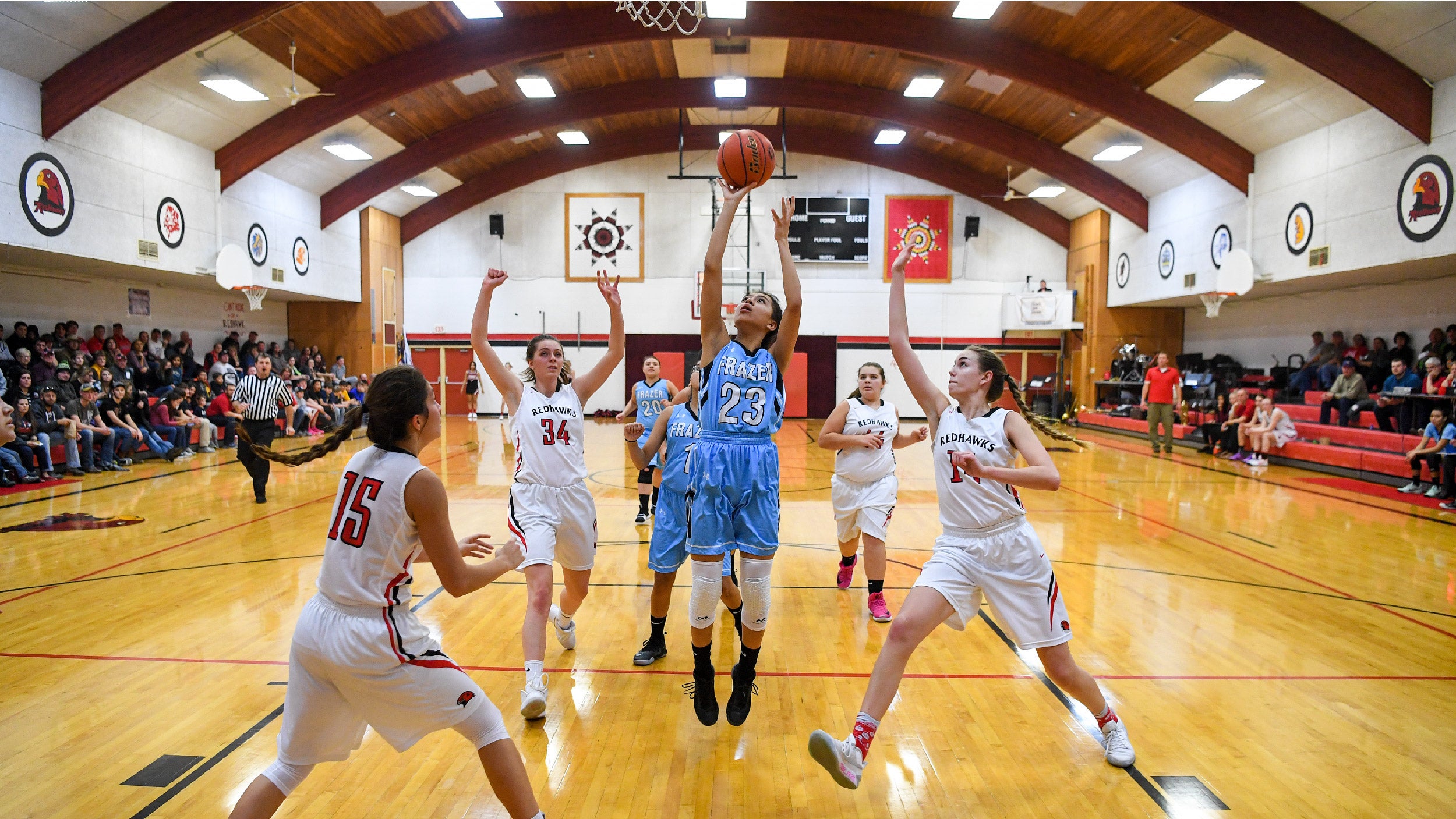 Mya Fourstar, 15, is a promising sophomore basketball player for the Frazer Lady Bearcubs on the Fort Peck Indian Reservation in the northeast corner of Montana. FRAZER, MT - DECEMBER 15: Mya Fourstar, 15, drives to the basket after splitting defenders during action against the the Froid Medicine Lake Redhawks. (Photo by Jonathan Newton/The Washington Post via Getty Images)