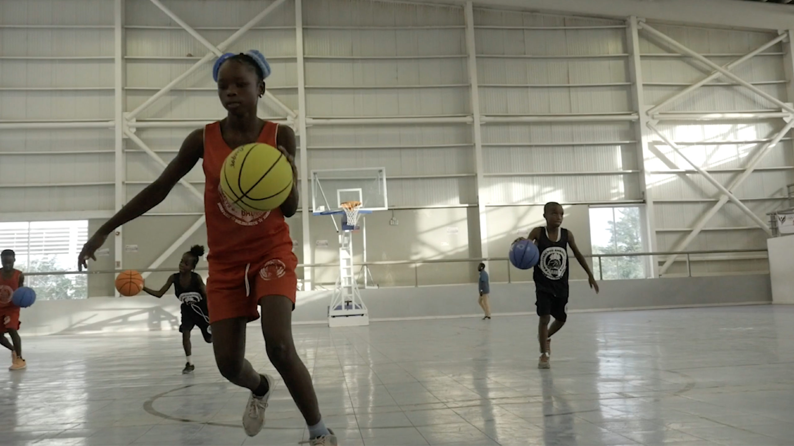 Children practice during a youth development program called Basketball to Uplift the Youth, otherwise known as Baskètbòl pou Ankadre Lajenès (BAL)