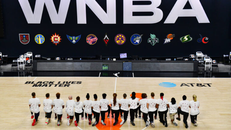 PALMETTO, FLORIDA - AUGUST 26: After the WNBA announcement of the postponed games for the evening, the Washington Mystics each wear white T-shirts with seven bullets on the back protesting the shooting of Jacob Blake by Kenosha, Wisconsin police at Feld Entertainment Center on August 26, 2020 in Palmetto, Florida. (Photo by Julio Aguilar/Getty Images)
