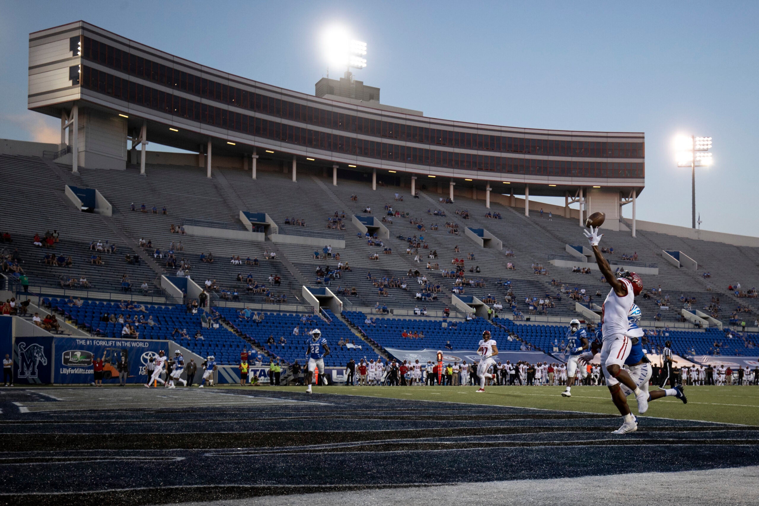 Football player reaching to catch ball