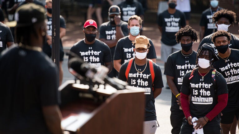 Football players at campus racial inequality demonstration