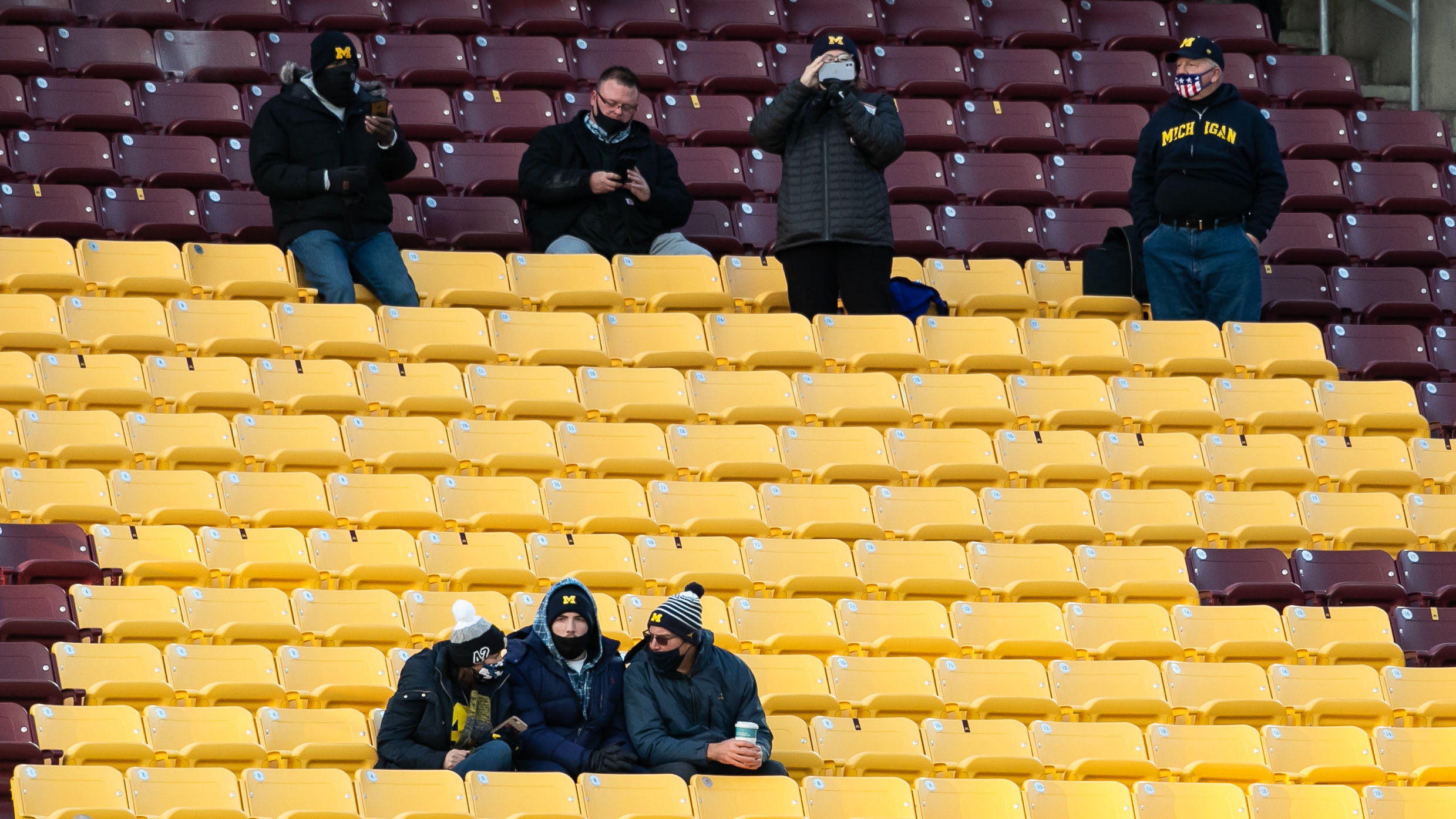 Michigan fans sitting socially distant with masks on