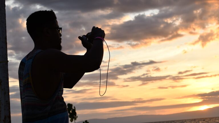 Rhasaan Nichols taking a photo of the sunset in Haiti