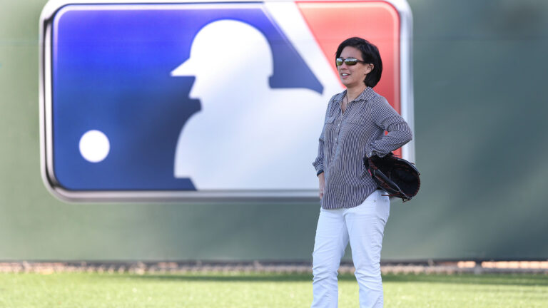 Photo of Kim Ng standing on a MLB field