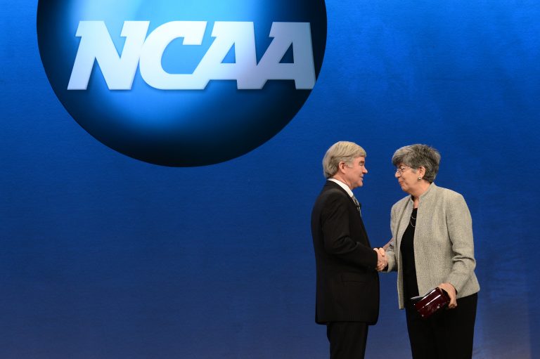 Donna Lopiano embraces Mark Emmert at an NCAA event.
